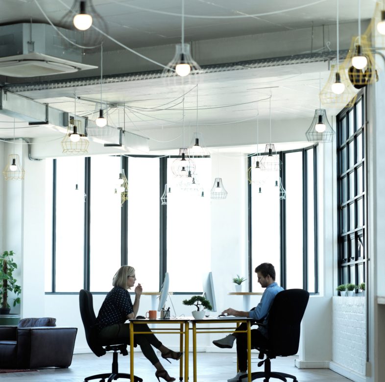 Office, corporate and colleagues on computer for report, review or online project at desk in coworking space. Employee, team and business people at startup for proposal, planning and creative design.